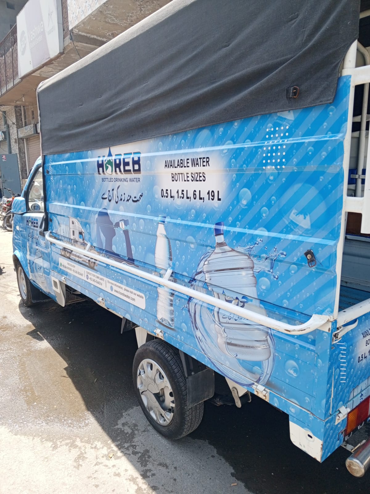 A branded Horeb water delivery van on the street